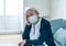 Depressed senior woman with facemask feeling lonely after loosing husband due to coronavirus