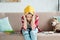 depressed teen student girl with book on head sitting on couch