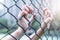 Depressed, trouble and solution. Women hand on chain-link fence.