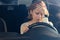 Depressed woman driver sitting in her car, feeling emotional burnout after work