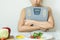 Depressed woman holding weight scales and look at vegetables in plate her bored healthy breakfast