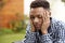 Depressed young African American  man with head in hands, close up, head and shoulders