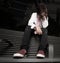 Depressed young boy sitting on a bus bench