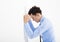 Depressed young business man leaning at the wall in office