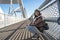 Depressed young woman and contemplating suicide, On the edge of a bridge with river below., Suicide and Major depressive disorder