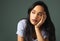 Depression can strike at anytime. Cropped shot of an attractive young woman looking depressed against a green background