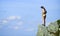 Depression concept. Brave woman stand alone in high mountains blue sky background. Soldier girl. Military female