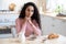 Depression Concept. Portrait Of Upset Pensive Woman Sitting At Table In Kitchen