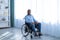 Depression in disabled patients. Portrait of paraplegic black man in wheelchair having psychological problems at home