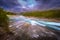 Depth effect of a landscape shot of a wild stream passing through the forest in the Lofoten Islands, Norway