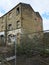 Derelict abandoned industrial mill in huddersfield england with boarded up and broken windows
