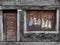 Derelict decaying shop building with boarded up window