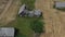 Derelict farm house ruins on agriculture field, aerial view