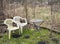 Derelict garden with old plastic weathered chairs in winter