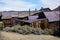 Derelict ghost town houses in western U.S. desert landscape