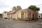 Derelict house and stray dog on the corner of a street in Mindelo on island Sao Vicente in Cape Verde