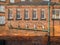 Derelict industrial buildings, with close-up on old plumbing pip