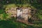 Derelict old door in stone wall covered by vegetation