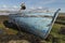 Derelict wooden fishing boat lies decaying on the shoreline of the Irish coast