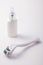 Dermaroller for medical micro needling therapy with bottle of medicaments. Derma roller mesoroller microneedle mesotherapy mesopen