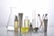 Dermatologist formulating and mixing pharmaceutical skincare, Cosmetic bottle containers and scientific glassware.