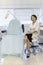 dermatologist sits in office near empty chair for examining patients. cosmetologist looks trustfully. Anti-aging