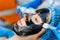 Dermatologist smears black mask on face for laser photorejuvenation and carbon peeling. Dermatology and cosmetology