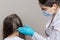 A dermatologist or trichologist applies a dandruff or lice weed to the patient& x27;s hair. Treating psoriasis, hair loss