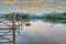 Derwentwater Calm with puffy bright orange clouds and blue rolling hills reflecting on Derwentwater in Keswick, England..