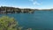 descending aerial footage of a gorgeous summer landscape at Lake Arrowhead with boats sailing across the water, homes