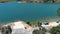 descending aerial footage of the rippling blue waters of Silverwood Lake with a beach and people swimming in the water