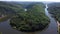 Descending aerial shot of saar loop river in Germany during sunny day