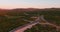 Descending aerial view of an empty new highway intersection in remote location