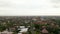 Descending aerial view of streets at Canggu city in Bali. Panoramic wide view of residential houses and small homes at