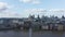 Descending shot of Thames river waterfront at Millennium bridge. Saint Pauls Cathedral with large dome and group of