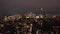 Descending and tilt up shot of night skyline. Panoramic view of cityscape with group of skyscrapers in City business