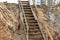 Descent into a deep pit during the construction of the building. Safety in construction. Ladder for descending to reinforced