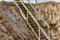 Descent into a deep pit during the construction of the building. Safety in construction. Ladder for descending to reinforced