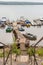 Descent to wooden bridge and parking lot small boats and motorboats on the river Volga.