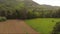 Descent towards the meadow in the distance of a beautiful forest and hill