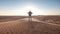 Desert adventure. Young man with backpack walking on sand dune. Dubai, United Arab Emirates