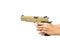 Desert color gun in hand ready to shoot on target on brown background with text space