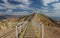 Desert dramatic scenery environment space sand stone rocky hill top with fenced path way to gazebo view point place