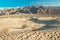 Desert hiking. Tourists hiking among sand dunes and taking photos of magnificent landscape. Mesquite Sand Dunes in Death Valley Na