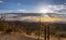 Desert Hiking Trail Sign With Sunbeams shinning on Mountains