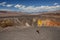 Desert hiking, Ubehebe Crater view point and warning sign `Use caution near the edge` in Death Valley, CA