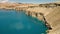 Desert lake basin with travertine rock cliffs.