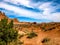 Desert landscape with barren land under wide skies and clouds, Arches National Park, UT, USA