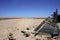 Desert landscape with broken wooden picket fence