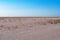 Desert landscape Chernomorskiy Biosphere Reserve near Zaliznyi port Kherson region, Ukraine. Empty sandy steppe against the blue